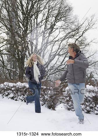 Italy, Piedmont, woman running after man in snow View Large Photo Image Picture - Italy, Piedmont, woman running after man in snow. Fotosearch
