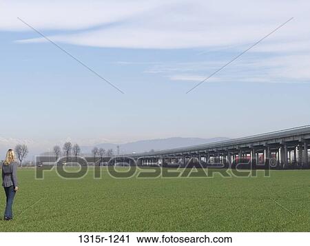 Italy, Piedmont, Woman standing in green field View Large Photo Image Stock Image - Italy, Piedmont, Woman standing in green field. Fotosearch