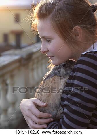 Italy, Teenage girl hugs pet rabbit on terrace View Large Photo Image Stock Photograph - Italy, Teenage girl hugs pet rabbit on terrace. Fotosearch