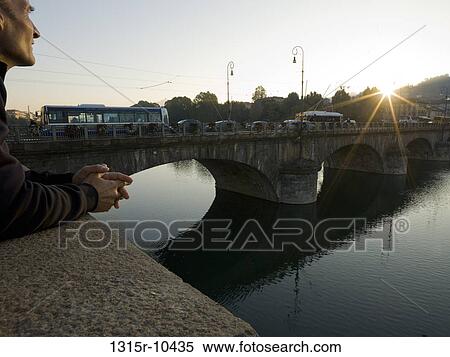 Italy, Turin, Man looking across Po River and bridge to sunrise View Large Photo Image Stock Photography - Italy, Turin, Man looking across Po River and bridge to sunrise. Fotosearch