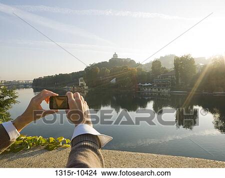 Italy, Turin, Woman taking cell phone picture across Po River View Large Photo Image Picture - Italy, Turin, Woman taking cell phone picture across Po River. Fotosearch