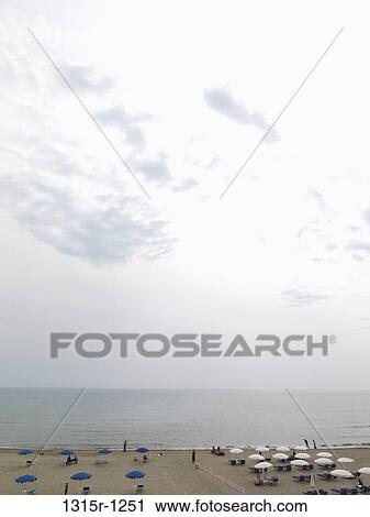 Italy, Tuscany, Castiglione della Pescaia, Beach umbrellas, sea and sky View Large Photo Image Stock Image - Italy, Tuscany, Castiglione della Pescaia, Beach umbrellas, sea and sky. Fotosearch