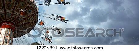 Low angle view of a group of people on an amusement park ride View Large Photo Image Stock Image - Low angle view of a group of people on an amusement park ride. Fotosearch