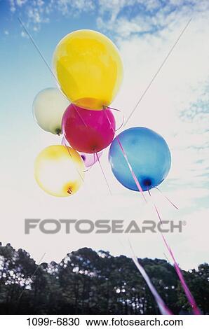 Low angle view of balloons on strings View Large Photo Image Stock Image - Low angle view of balloons on strings. Fotosearch