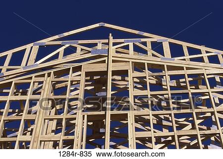 Stock Photography - Low angle view of the wooden framework of a house under construction. Fotosearch