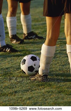 Stock Photo - Low section view of soccer players feet and a soccer ball. Fotosearch