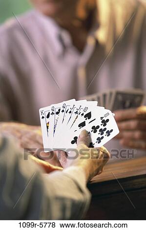 Stock Photo - Man holding playing cards. Fotosearch