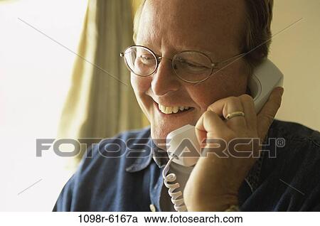 Stock Image - Mature man talking on a telephone. Fotosearch