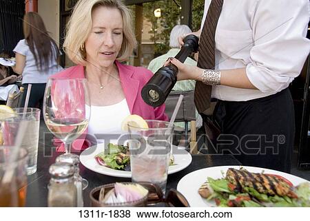 Mature woman sitting at a table in a restaurant View Large Photo Image Stock Photo - Mature woman sitting at a table in a restaurant. Fotosearch