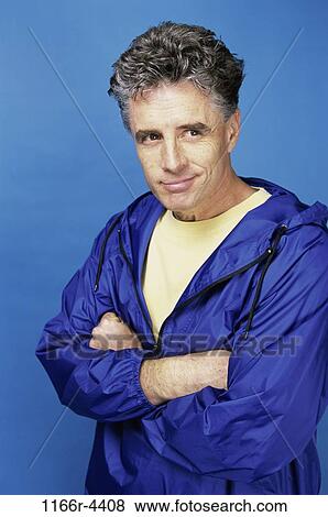 Mid adult man standing with his arms folded View Large Photo Image Stock Photo - Mid adult man standing with his arms folded. Fotosearch