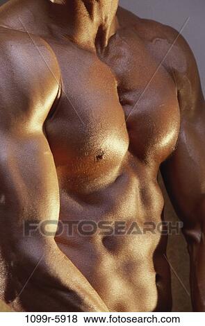 Stock Photo - Mid section view of a young man flexing his muscles. Fotosearch