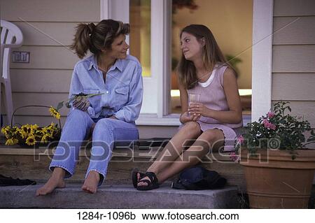 Stock Image - Mother and her daughter sitting on steps together. Fotosearch