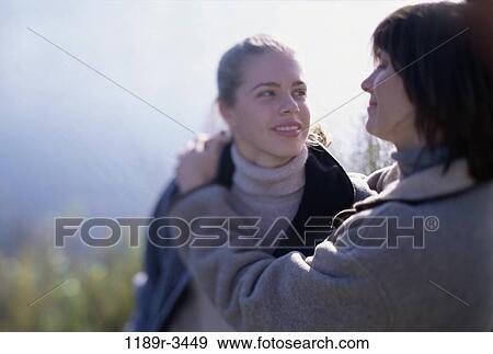 Stock Photo - Mother and her daughter smiling. Fotosearch