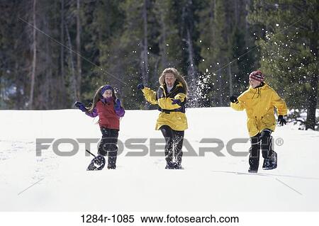 Mother and her two children playing in the snow View Large Photo Image Stock Photography - Mother and her two children playing in the snow. Fotosearch