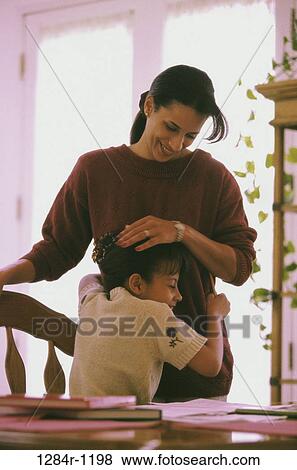 Mother holding her daughter View Large Photo Image Stock Photo - Mother holding her daughter. Fotosearch