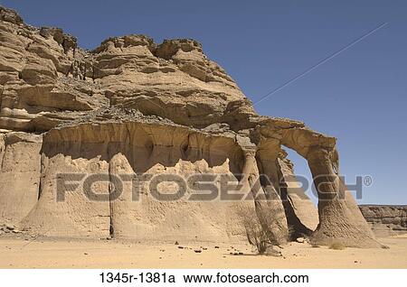 Natural arch formed in a desert, Fezzi Jaren Arch, Wadi Teshuinat, Tadrart Acacus, Fezzan, Libya View Large Photo Image Stock Image - Natural arch formed in a desert, Fezzi Jaren Arch, Wadi Teshuinat, Tadrart Acacus, Fezzan, Libya. Fotosearch