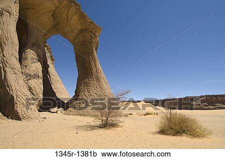 Natural arch formed in a desert, Fezzi Jaren Arch, Wadi Teshuinat, Tadrart Acacus, Fezzan, Libya View Large Photo Image Stock Image - Natural arch formed in a desert, Fezzi Jaren Arch, Wadi Teshuinat, Tadrart Acacus, Fezzan, Libya. Fotosearch