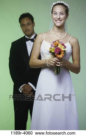 Stock Image - Newlywed couple standing together. Fotosearch