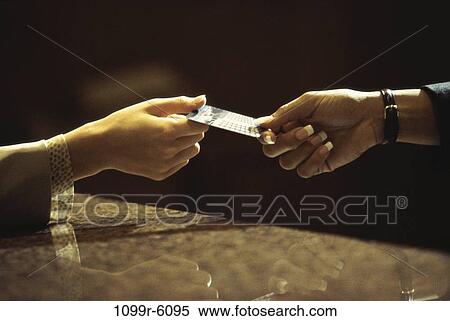 Person handing another person a credit card View Large Photo Image Stock Photography - Person handing another person a credit card. Fotosearch