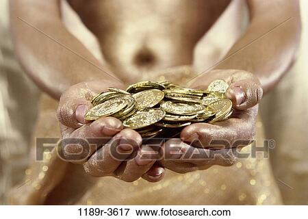 Person holding gold coins View Large Photo Image Stock Photo - Person holding gold coins. Fotosearch