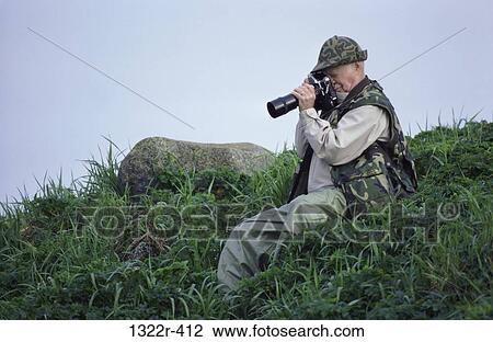 Photographer taking a snapshot outdoors View Large Photo Image Stock Image - Photographer taking a snapshot outdoors. Fotosearch