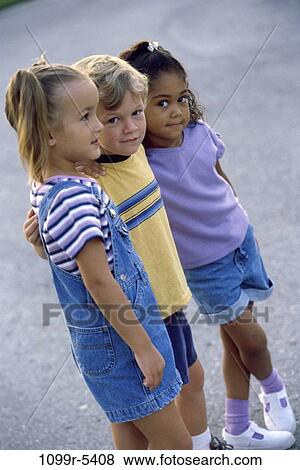 Portrait of a boy and two girls standing together View Large Photo Image Stock Photo - Portrait of a boy and two girls standing together. Fotosearch