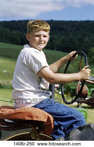 Portrait of a boy driving a farm tractor View Large Photo Image Stock Image - Portrait of a boy driving a farm tractor. Fotosearch