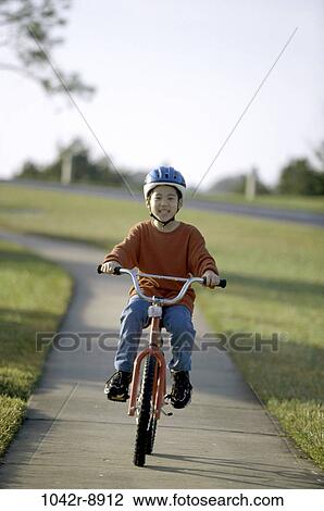 Portrait of a boy riding a bicycle View Large Photo Image Stock Image - Portrait of a boy riding a bicycle. Fotosearch