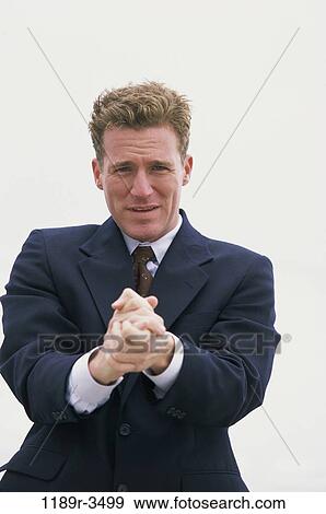 Stock Photo - Portrait of a businessman pleading. Fotosearch