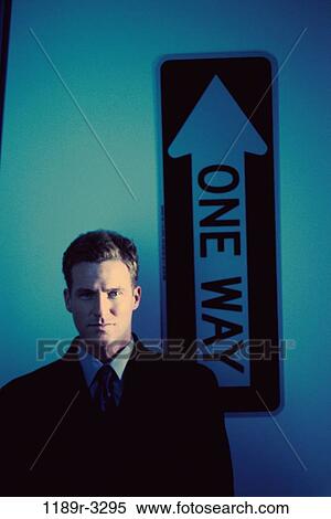 Portrait of a businessman standing in front of a street sign View Large Photo Image Stock Photography - Portrait of a businessman standing in front of a street sign. Fotosearch