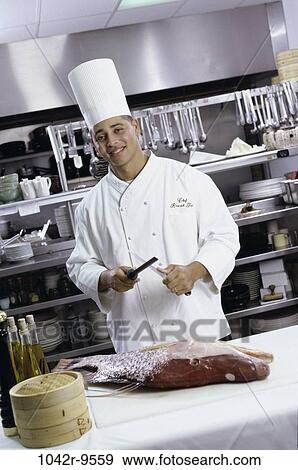 Portrait of a chef sharpening a knife View Large Photo Image Stock Photo - Portrait of a chef sharpening a knife. Fotosearch