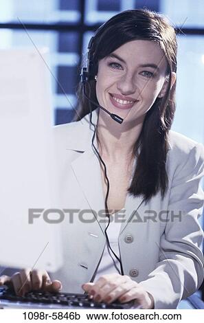 Stock Image - Portrait of a customer service representative wearing a headset. Fotosearch