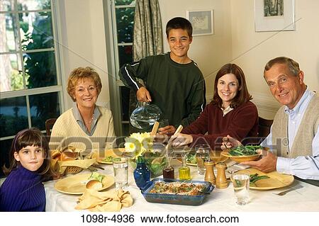 Stock Photograph - Portrait of a family having dinner. Fotosearch