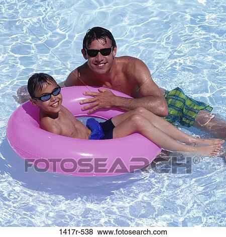 Portrait of a father and his son in a swimming pool View Large Photo Image Stock Photo - Portrait of a father and his son in a swimming pool. Fotosearch