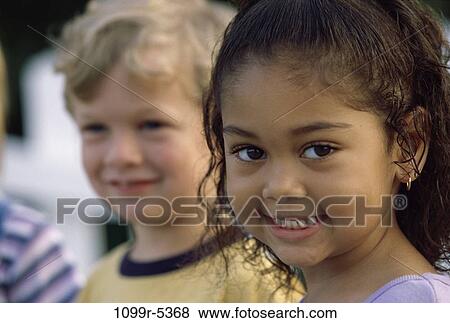 Portrait of a girl and a boy smiling View Large Photo Image Stock Photo - Portrait of a girl and a boy smiling. Fotosearch