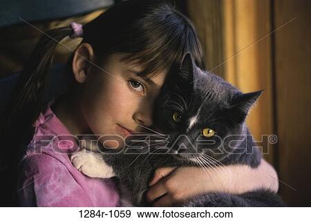 Portrait of a girl holding a cat View Large Photo Image Stock Photo - Portrait of a girl holding a cat. Fotosearch