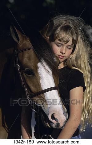 Portrait of a girl holding a Welsh pony View Large Photo Image Stock Photo - Portrait of a girl holding a Welsh pony. Fotosearch