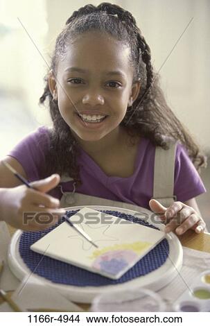 Portrait of a girl painting on a tile View Large Photo Image Picture - Portrait of a girl painting on a tile. Fotosearch