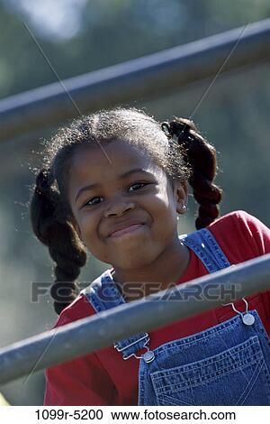Stock Image - Portrait of a girl playing on a playground. Fotosearch