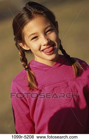 Stock Photo - Portrait of a girl sticking out her tongue. Fotosearch