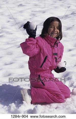 Picture - Portrait of a girl throwing snowballs. Fotosearch