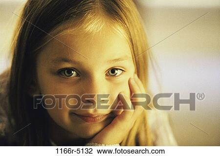 Portrait of a girl with her hand on her chin View Large Photo Image Stock Image - Portrait of a girl with her hand on her chin. Fotosearch