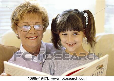 Stock Image - Portrait of a grandmother and her granddaughter smiling. Fotosearch