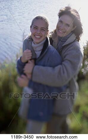 Portrait of a mother and her daughter holding each other View Large Photo Image Stock Image - Portrait of a mother and her daughter holding each other. Fotosearch