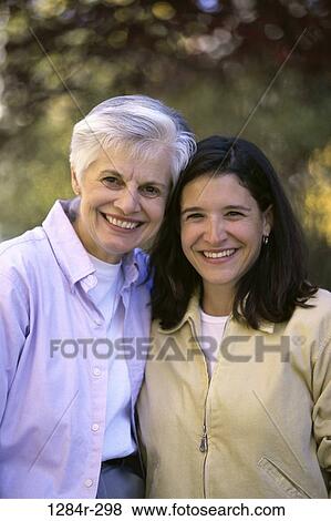 Portrait of a mother and her daughter smiling View Large Photo Image Stock Photo - Portrait of a mother and her daughter smiling. Fotosearch