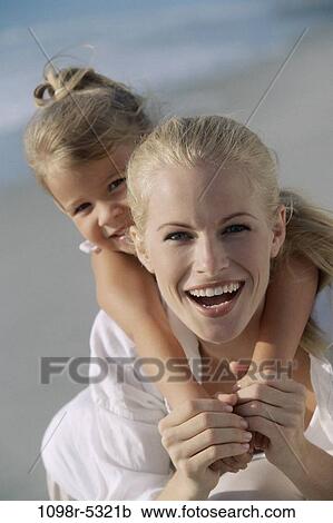 Portrait of a mother carrying her daughter on her back View Large Photo Image Stock Image - Portrait of a mother carrying her daughter on her back. Fotosearch