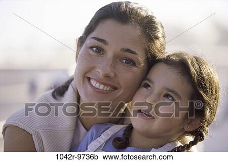 Portrait of a mother holding her daughter View Large Photo Image Stock Image - Portrait of a mother holding her daughter. Fotosearch