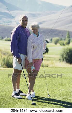 Picture - Portrait of a senior couple playing golf. Fotosearch