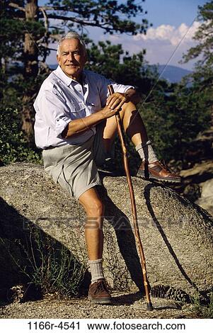 Portrait of a senior man sitting on a rock View Large Photo Image Stock Image - Portrait of a senior man sitting on a rock. Fotosearch