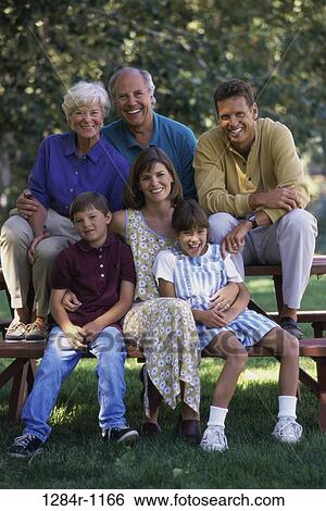 Portrait of a three generation family in a park View Large Photo Image Stock Photograph - Portrait of a three generation family in a park. Fotosearch